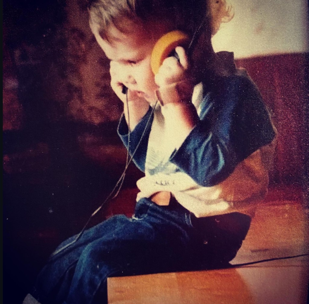 Wes as a child listening on headphones